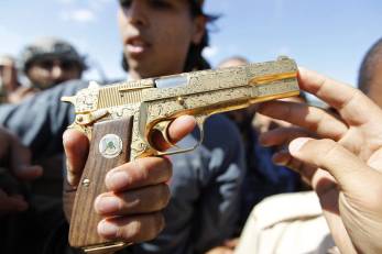 Gadaffi's Hi-Power, flourished with typical Libyan gun-handling skill.